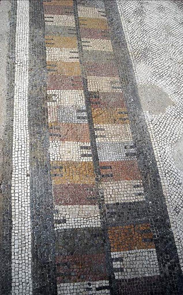 VII.7.5 Pompeii. 2014. Exedra (u) coloured mosaic floor threshold with castellated pattern.