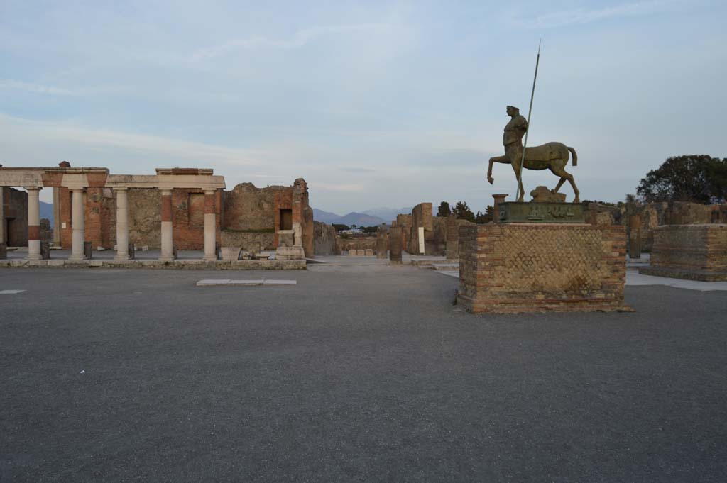 VII.8 Pompeii Forum. March 2019. 
Looking towards east side, with portico of Eumachia’s building at VII.9.1, on left, and entrance/exit to Via dell’Abbondanza, in centre.
Foto Taylor Lauritsen, ERC Grant 681269 DÉCOR.

