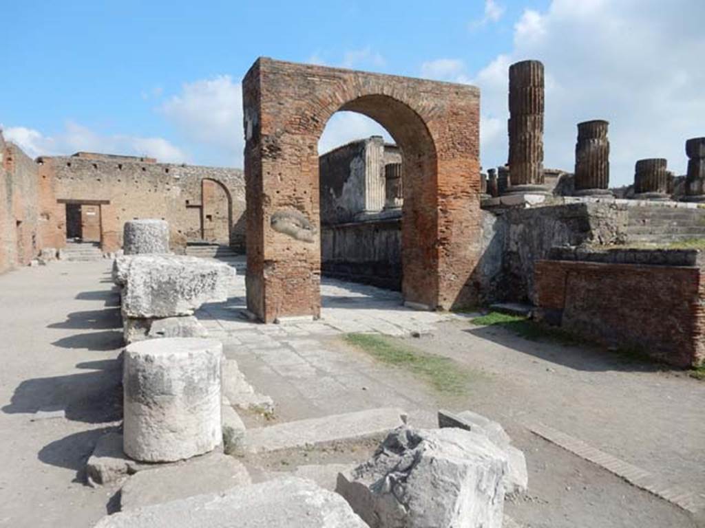 VII.8.1 Pompeii. May 2015. Looking towards Arch of Augustus and Temple of Jupiter, in north-west corner of Forum.
Photo courtesy of Buzz Ferebee.
For a description of excavations carried out on the north side of the Temple, and in the north-west corner of the Forum (west side of Temple),
See Notizie degli Scavi, 1942, (p.309-320).

