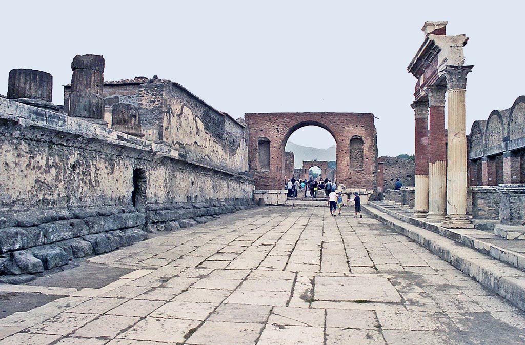 VII.8.1 Pompeii. October 2001. 
Looking north along the east side of the Temple of Jupiter, on left, towards the Arch and Via del Foro. Photo courtesy of Peter Woods.
