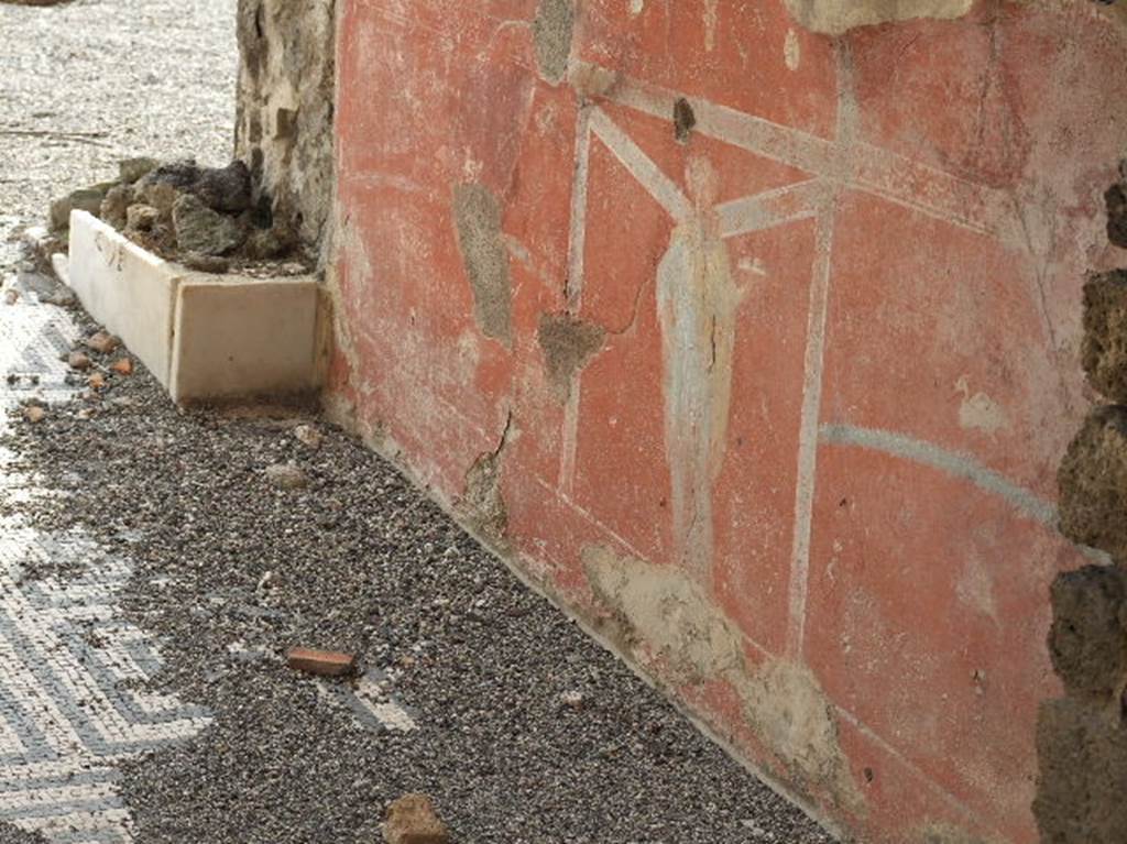 VIII.2.26 Pompeii. December 2005. Painted wall decoration on west wall of vestibule ‘b’.
According to NdS – “The walls were painted black with red zoccolo.
On the wall to the right (west) in the central square was a painted standing female figure (0.46 high), crowned with fronds, with grey robe and yellow cloak, holding in her left hand a round plate with fruit; and on the left wall (east) was another crowned female figure (0.48 high), with yellow robe and greenish cloak, between her hands was a long torch.”
See Notizie degli Scavi di Antichità, 1888, (p. 512)


