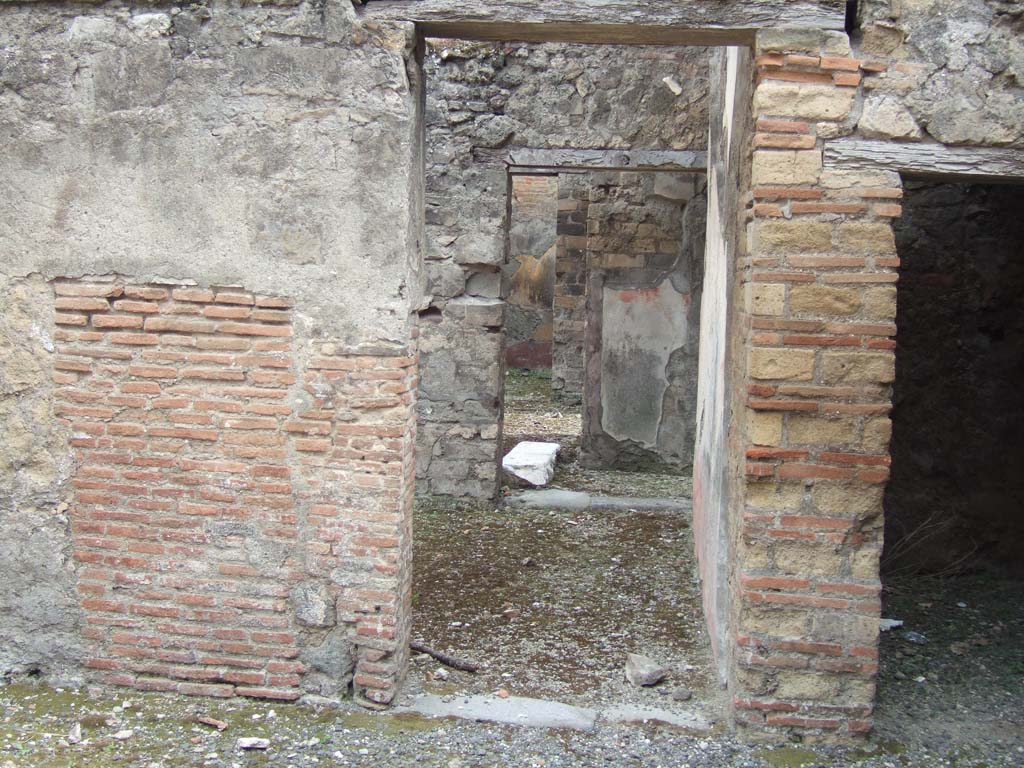 VIII.3.11 Pompeii. May 2006. 
Doorway (centre) in south wall, leading into triclinium with window, and doorway into space near entrance at VIII.3.12.
