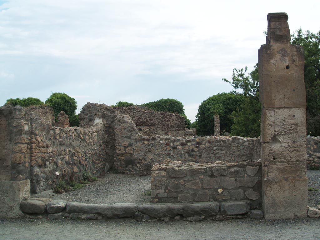 VIII.3.29 Pompeii. May 2005. Looking east to masonry counter with hearth. 
On the left would have been the stairs to the upper floor. 
In the south-east corner [NE corner?] there was a drainpipe from above, no longer visible, and a latrine.
See Eschebach, L., 1993. Gebäudeverzeichnis und Stadtplan der antiken Stadt Pompeji. Köln: Böhlau. (p. 368)
