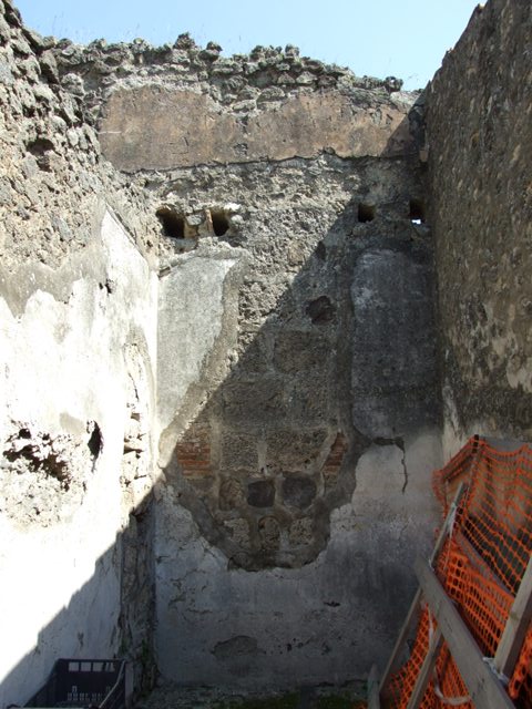 VIII.4.4 Pompeii. March 2009. Room 3, looking east. According to PPM in the north-east corner were the remains of a moulded stucco cornice. The holes for the supports of the floor joists of the room above could be seen. A large hole, filled by the restorers, was left as a sign of ancient searchers in the room. The decorative scheme from the short wall is completely lost. The zoccolo was red, in a side panel of the middle zone was a painting showing the head of Silenus.
See Helbig, W., 1868. Wandgemälde der vom Vesuv verschütteten Städte Campaniens. Leipzig: Breitkopf und Härtel, (413). See Pompei: Pitture e Mosaici, Vol. VIII parte 1, Roma: Istituto della enciclopedia italiana, pp. 451ff. 
