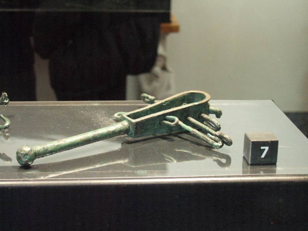 Bronze sistrum found in VIII.4.5.  Now in Naples Archaeological Museum.