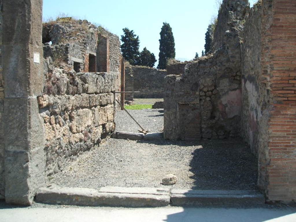 VIII.4.12 Pompeii. May 2005. Looking south across shop to dwelling at rear.