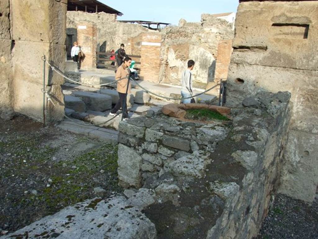 VIII.4.17a Pompeii. December 2007. Looking east over podium with built in dolium and onto Via Stabiana.
