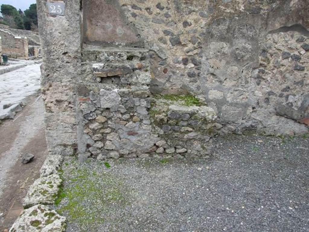 VIII.4.25 Pompeii. December 2007. Remains of podium against south wall of shop, and remains of three shelves for glasses and crockery.