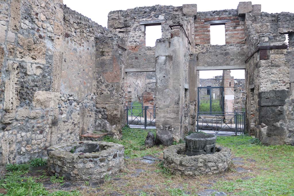 VIII.4.26 Pompeii, on left, and VIII.4.27, on right. December 2018. 
Looking east across bakery towards entrance doorways onto Via Stabiana. Photo courtesy of Aude Durand.
