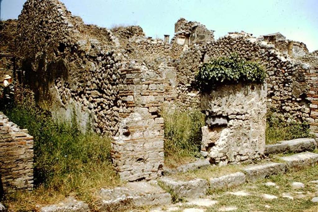 VIII.4.33 Pompeii on left, VIII.4.32 in centre, and VIII.4.31 on right. 1959. 
Looking towards entrance doorways on Via del Tempio dIside. Photo by Stanley A. Jashemski.
Source: The Wilhelmina and Stanley A. Jashemski archive in the University of Maryland Library, Special Collections (See collection page) and made available under the Creative Commons Attribution-Non Commercial License v.4. See Licence and use details.
J59f0269

