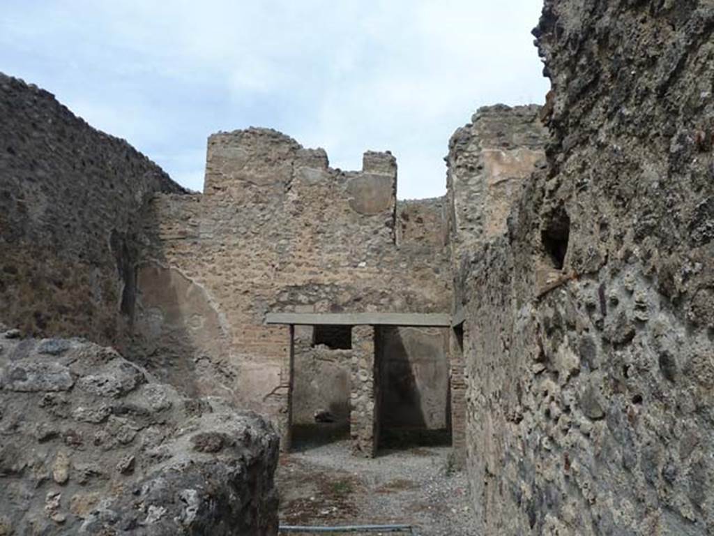 VIII.4.37 Pompeii. September 2015. Looking north from entrance corridor into central courtyard with two doorways in its north wall, and doorway to corridor in the east wall, on right. According to Eschebach, this room was either a small cavaedium (central courtyard) or a sitting room.
See Eschebach, L., 1993. Gebäudeverzeichnis und Stadtplan der antiken Stadt Pompeji. Köln: Böhlau. (p.376-7)


