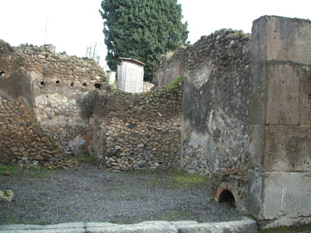 VIII.4.47 Pompeii. December 2004. South side of shop, with hearth at the front near entrance.