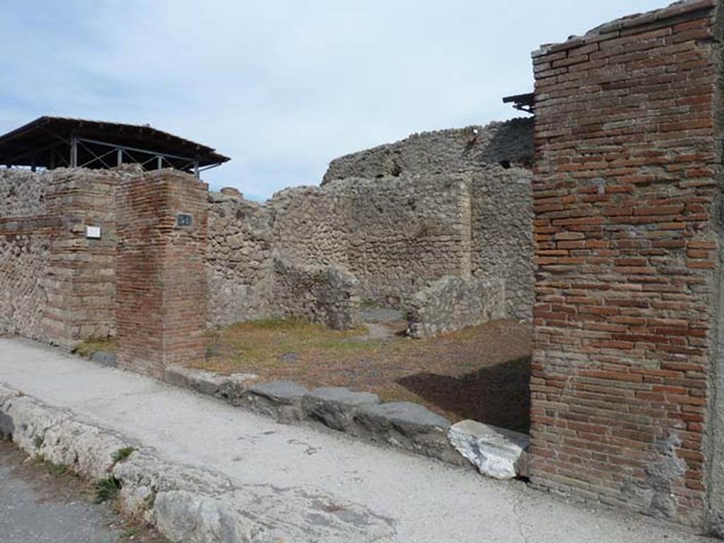 VIII.4.51 Pompeii. September 2015. Looking north to entrance doorway on east side of Via dei Teatri.