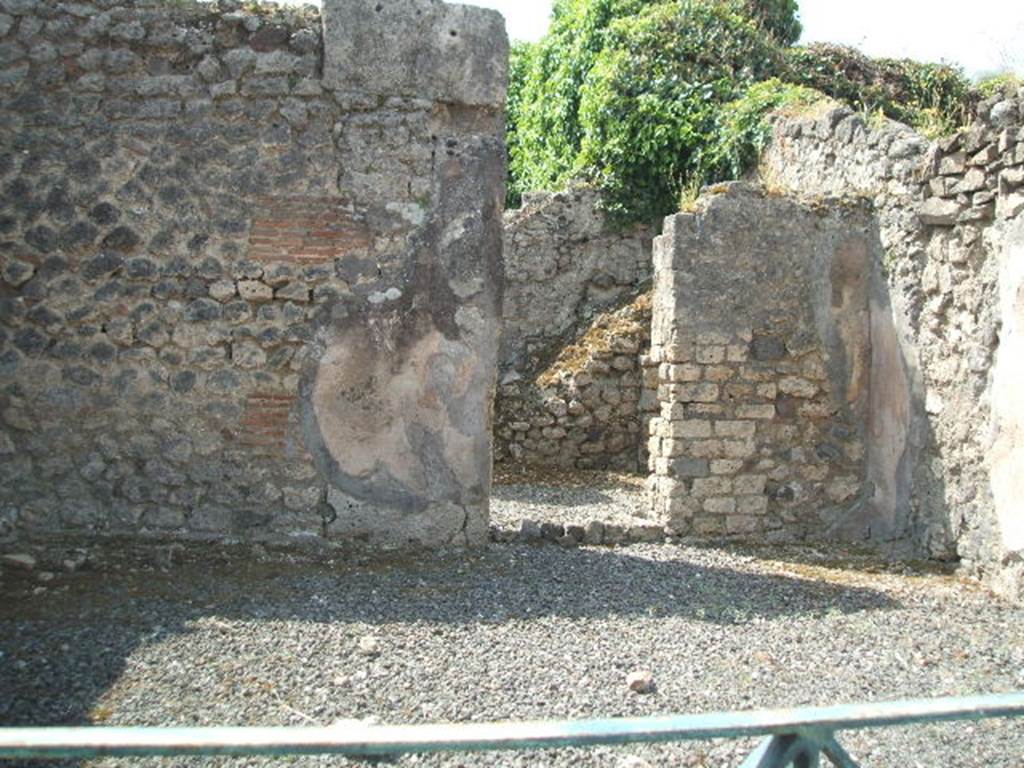 VIII.5.8 Pompeii.  Shop.  May 2005.  South wall with door to room containing stairs to upper floor.