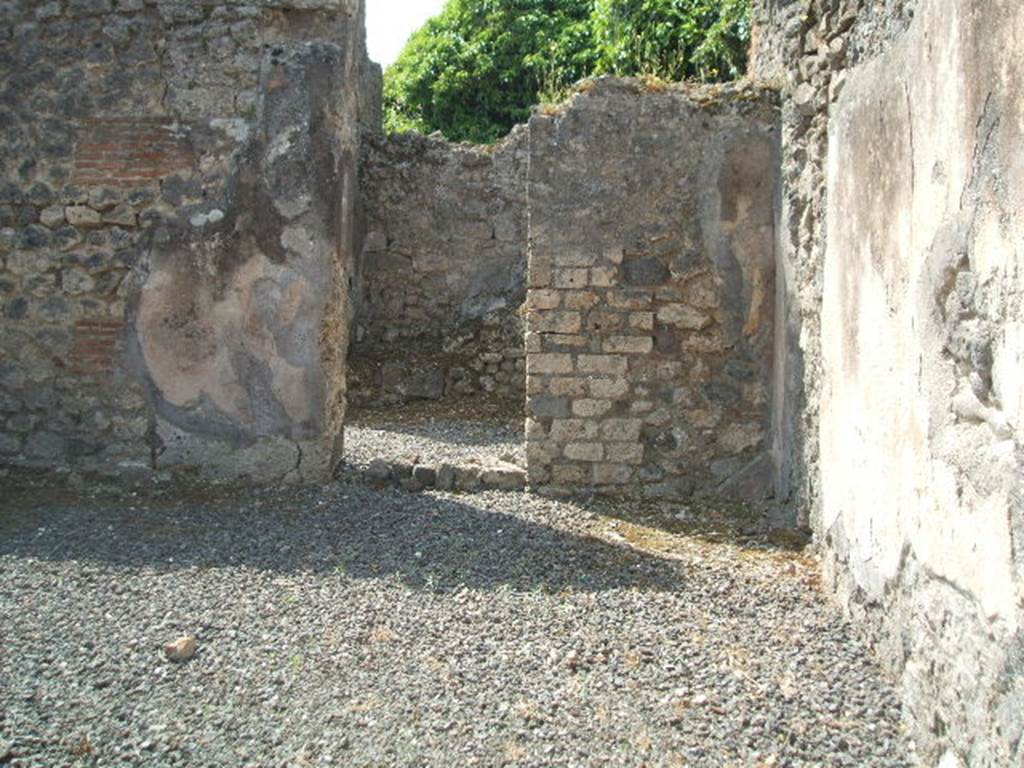 VIII.5.8 Pompeii. May 2005. South wall and south-west corner of shop, with doorway to room containing stairs to upper floor.