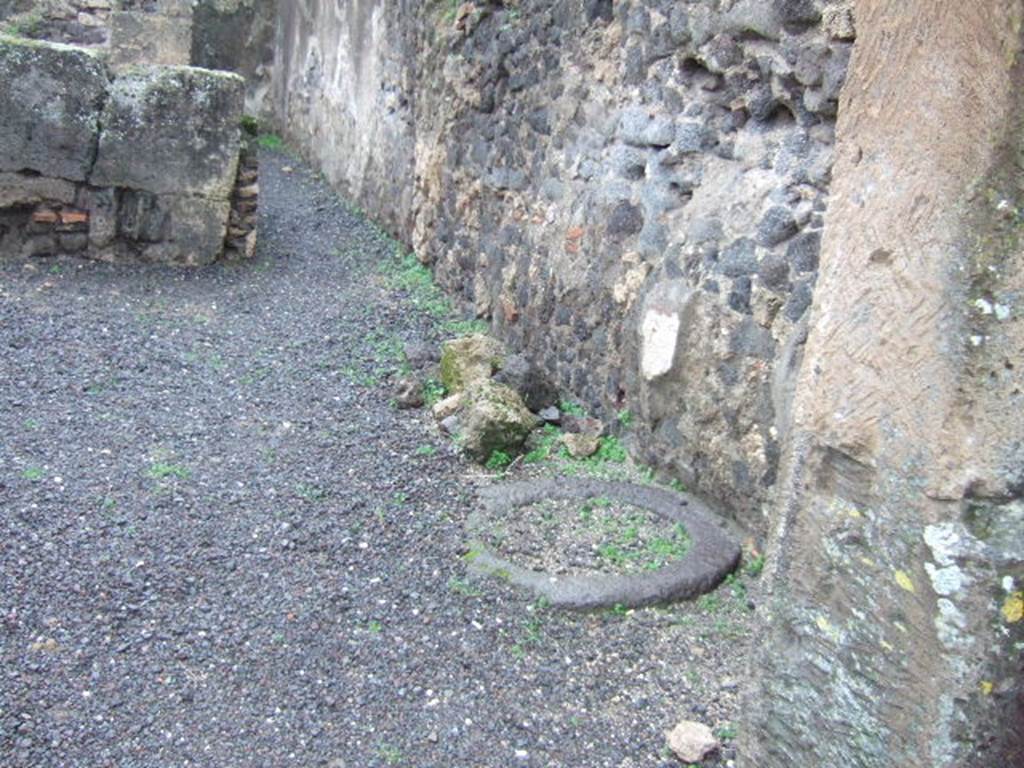 VIII.5.21 Pompeii.  Shop and room.  December 2005.   Cistern or well head next to west wall.