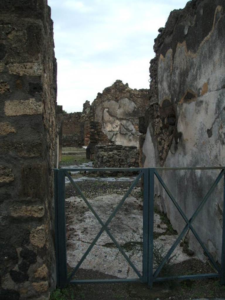 VIII.6.1 Pompeii. December 2004. Entrance corridor, looking north.  On entering the entrance corridor immediately from the roadway, this lead to the bakery, where the sub-structures for the four mills can be seen with flooring around them for the mules The walls were painted simply in the last style, with red and yellow compartments. See BdI, 1884, p.137, where the entrance is described as N. [7-9] 
