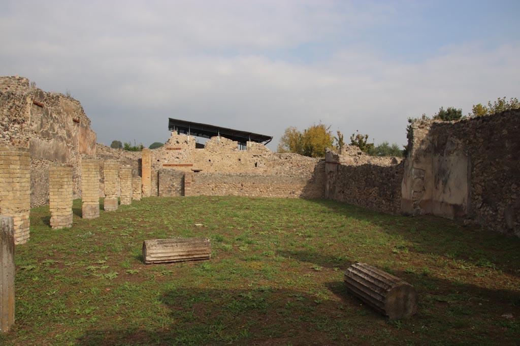 VIII.6.2 Pompeii. October 2023. 
Looking north from entrance doorway, with tufa columns and brick pilasters of portico. Photo courtesy of Klaus Heese.

