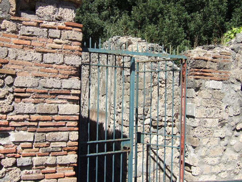 VIII.6.5 Pompeii. September 2005. Entrance.
According to PPM, this doorway is numbered as VIII.6.4.
See Pompei: Pitture e Mosaici, Vol. VIII parte 1, Roma: Istituto della enciclopedia italiana,  (p.687).
On the right (east) of the entrance corridor is a narrow room, now blocked off, which was probably a narrow room with the stairs to the upper floor. On the left (west) of the entrance corridor is a doorway to a small room.
The narrow vestibule/entrance corridor leads to the atrium.

