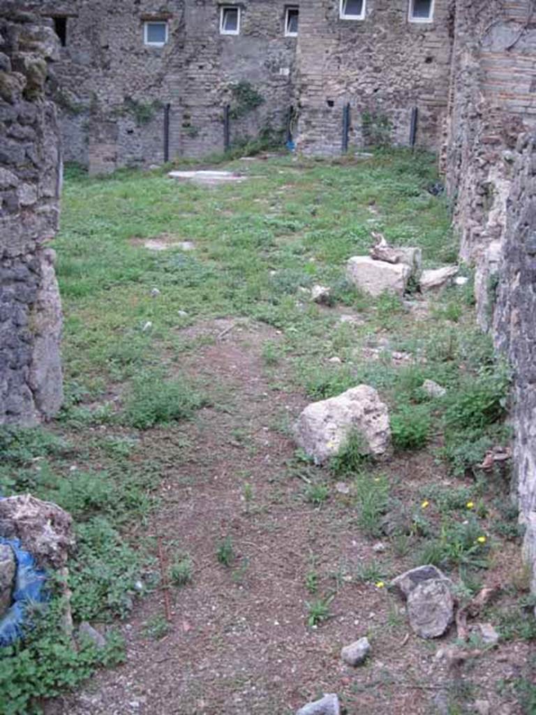 VIII.7.10 Pompeii. September 2010. Looking west from kitchen across garden, linked to VIII.7.6 and VIII.7.11. In the upper centre, near the modern wall, would have been the latrine. In this garden, near the south wall, there would have been another triclinium that had a pergola in antiquity. Photo courtesy of Drew Baker.

