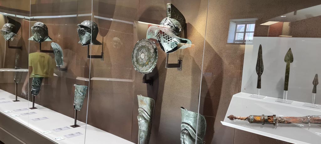 Naples Archaeological Museum, display case with gladiator armour. Photo taken May 2021. Photo courtesy of Giuseppe Ciaramella.

