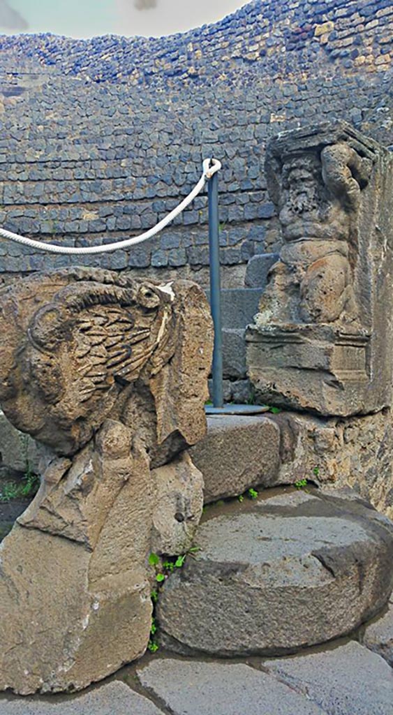 VIII.7.19 Pompeii. 2015/2016. 
East side, stone seating, the Lion’s foot and the Kneeling Atlas.
Photo courtesy of Giuseppe Ciaramella.

