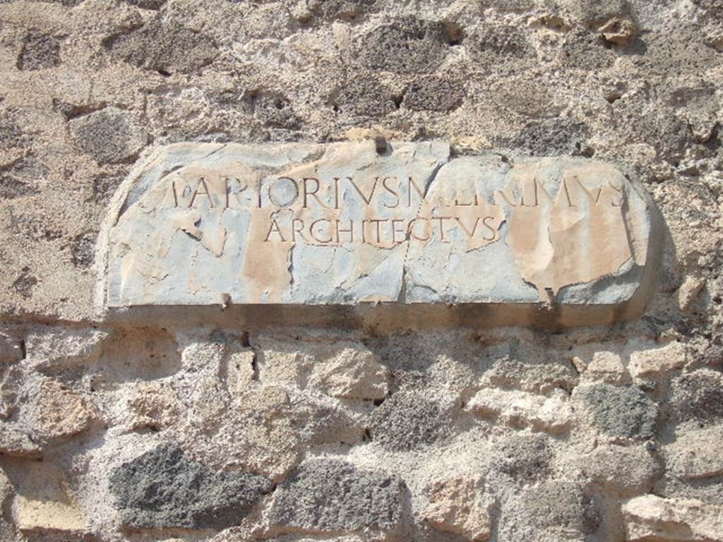 VIII.7.21 Pompeii. September 2005. Plaque on wall between theatres.

M(ARCVS) ARTORIVS M(ARCI) L(IBERTVS) PRIMVS
ARCHITECTVS

M(arcus) Artorius M(arci) l(ibertus) Primus / architectus

Marcus Artorius Primus, freedman of Marcus, architect.
See Cooley, A. and M.G.L., 2004. Pompeii : A Sourcebook. London : Routledge. (p.67, D52). CIL X 841=ILS 5638a.