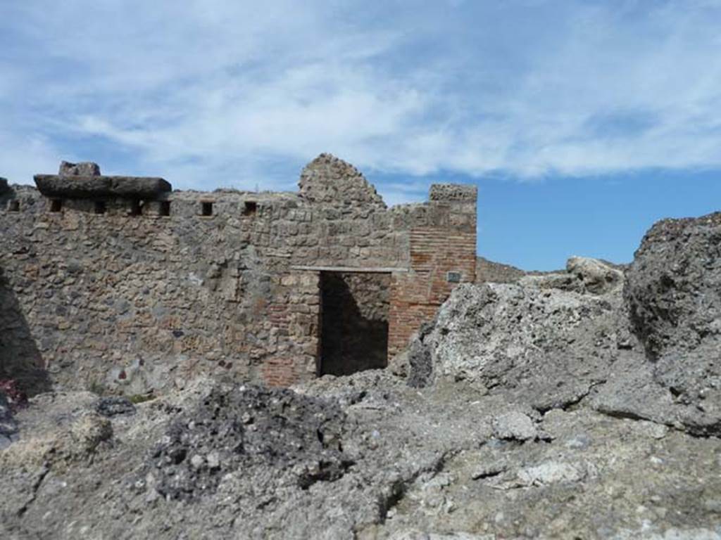 VIII.7.23 Pompeii. September 2015. North wall of shop, with doorway to small room or latrine, on right.