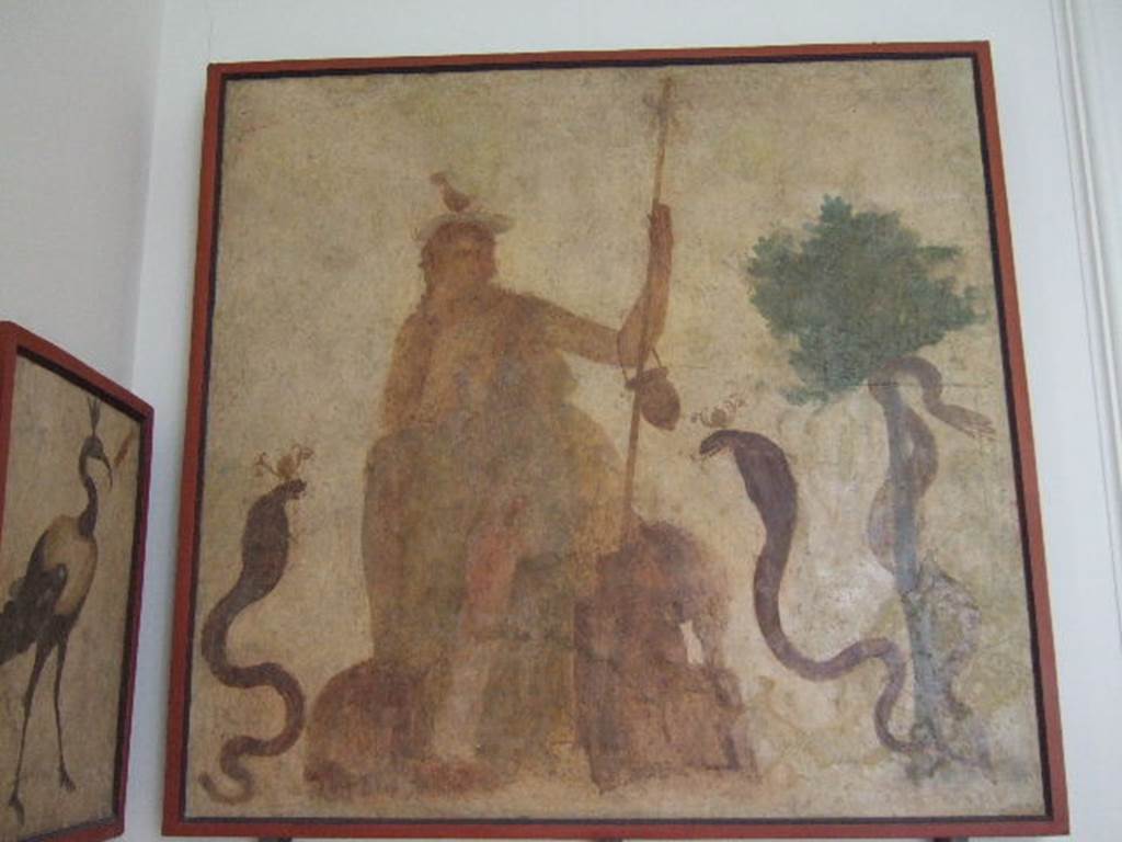 VIII.7.28 Pompeii. West wall of sacrarium. Painting of god Osiris on a throne and with cobras. 
Now in Naples Archaeological Museum. Inventory number 8927.
