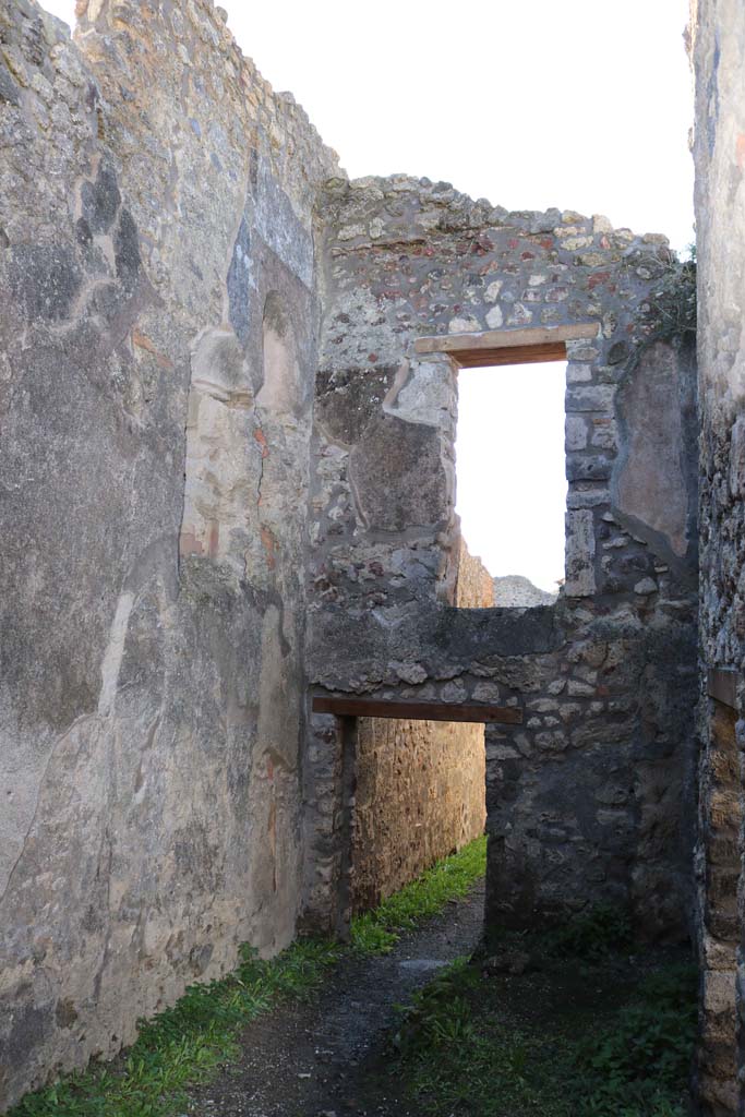 IX.2.8 Pompeii. December 2018. 
Looking west from rear room, looking towards south-west corner with niche latrine in upper wall and downpipe below.
Photo courtesy of Aude Durand.
