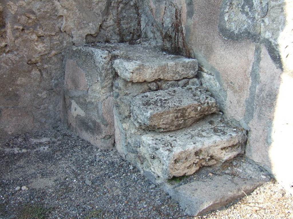 IX.2.9 Pompeii. September 2005. Stone steps to upper floor in north-east corner of rear room. The upper part of the stairs would have continued in wood. 
