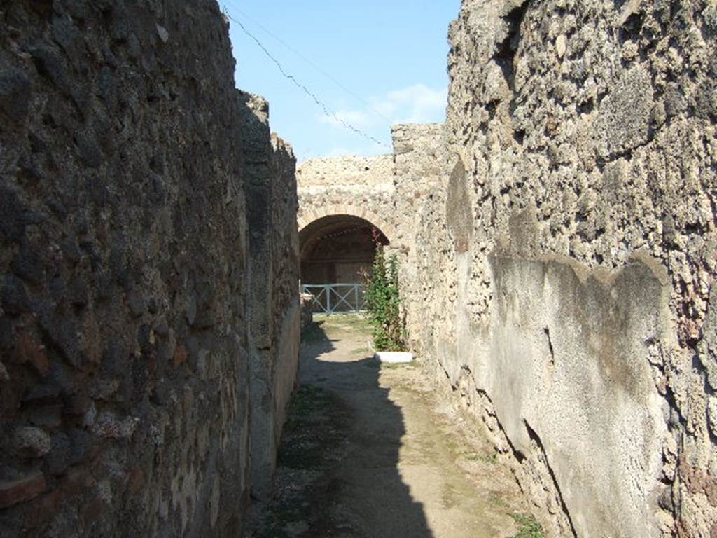 IX.2.10 Pompeii. September 2005. Looking east along entrance corridor.  On the walls, the high zoccolo would have been black and subdivided into panels by narrow red bands. The upper zone of the walls would have been painted white.

