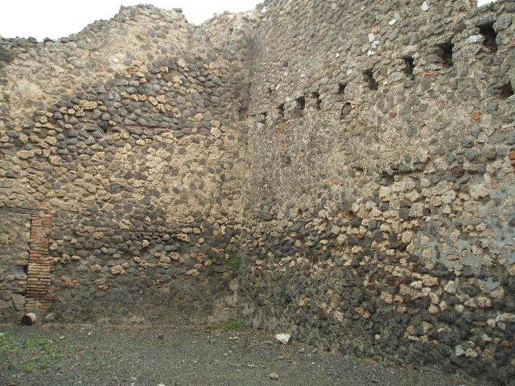 IX.2.14 Pompeii. May 2005. Looking across large room towards north-east corner, with blocked doorway in north wall.