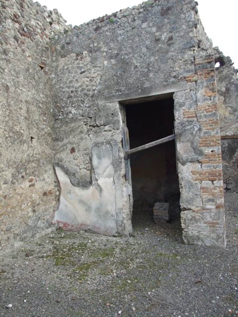 IX.2.21 Pompeii. March 2009. Doorway to room 2, from atrium. According to Bragantini, to the east of this doorway the dado would have been seen to be low and red. The middle zone of the wall was colourless.
See Bragantini, de Vos, Badoni, 1986. Pitture e Pavimenti di Pompei, Parte 3. Rome: ICCD. (p.422, atrio ‘b’) 
