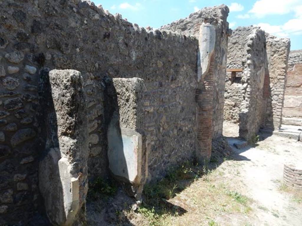 IX.2.27 Pompeii. May 2017.  Remains of shrine on wall of peristyle, looking north along west wall towards doorway to kitchen/latrine. Photo courtesy of Buzz Ferebee.
