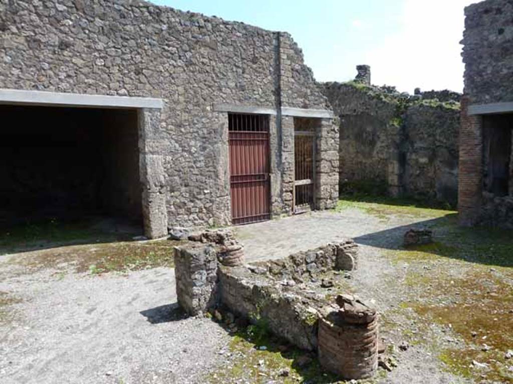 IX.2.27 Pompeii. May 2010. Looking south-east from entrance across the remains of the portico towards the workshop.
