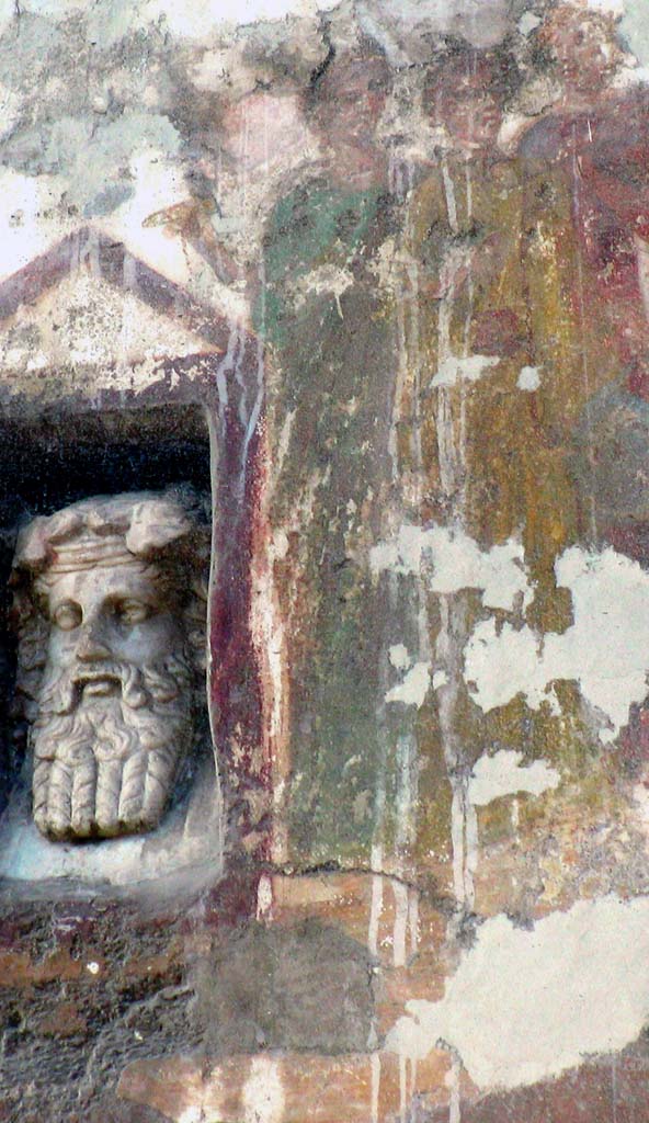 IX.7.1 Pompeii. March 2008. Fresco with a little marble bust of Dionysus. 
Marble bust of Dionysus in niche, on left, fresco showing the procession in honour of the goddess Cybele, on right.
Photo courtesy of Davide Peluso.
