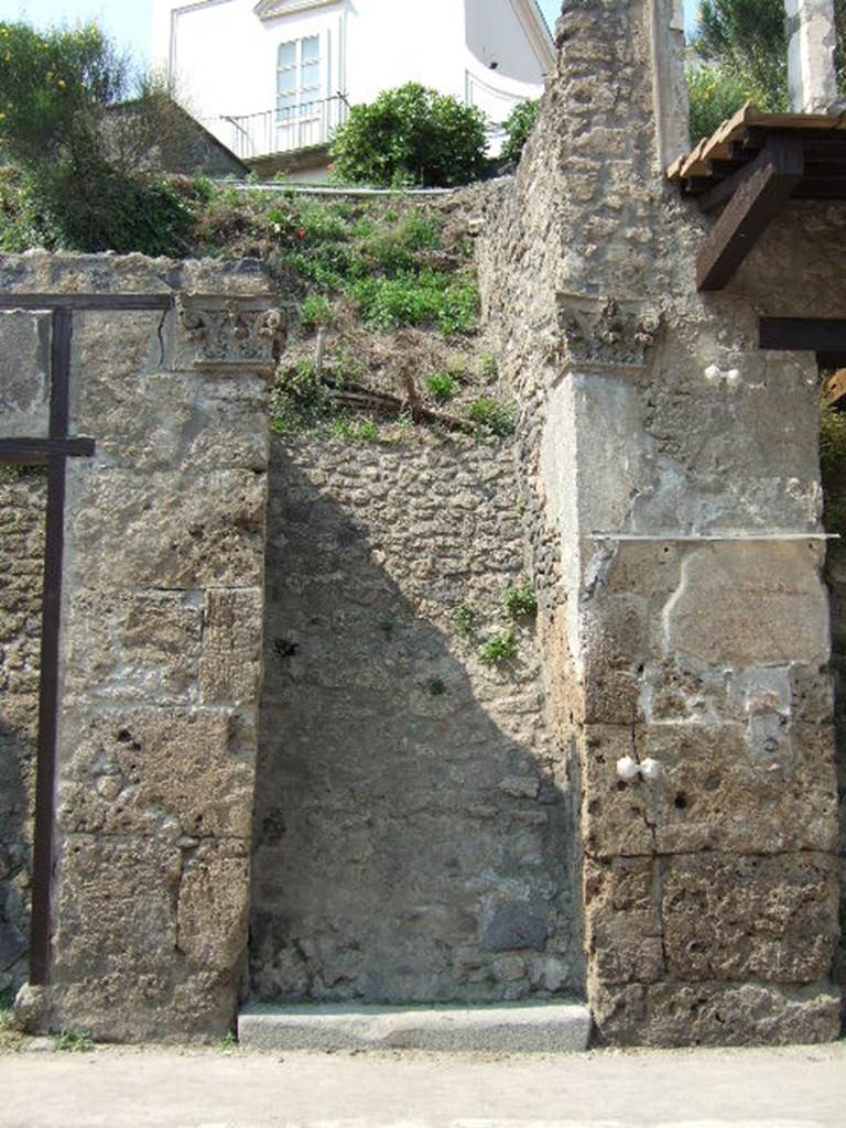 IX.7.3 Pompeii. May 2006. Blocked entrance doorway, with two Corinthian pilasters. According to Della Corte, this house owned by a person called Coniunctus was unlikely to have been a different person from P. Sittius Coniunctus, already noted as candidate to the municipal office and member of one of the most old and distinct pompeian families. 
Graffito found to the right of the entrance read –
(P. Sittius?) Coniunctus facit.  [CIL IV 7817] See Della Corte, M., 1965.  Case ed Abitanti di Pompei. Napoli: Fausto Fiorentino. (p.281)
According to Epigraphik-Datenbank Clauss/Slaby (See www.manfredclauss.de) this read as -
P(ublium)  Vedium  Nummianum 
aed(ilem)  v(iis)  aed(ibus)  s(acris)  p(ublicis)  p(rocurandis)  Coniunctus 
facit      [CIL IV 7817]

