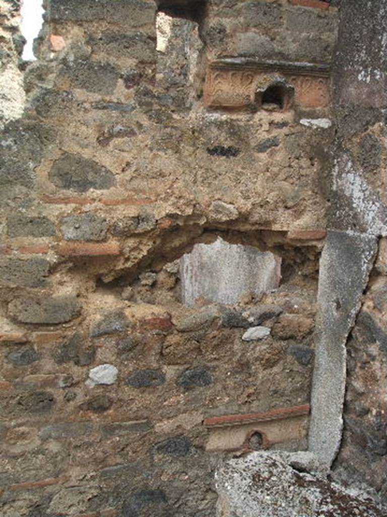 IX.7.21 Pompeii. May 2005. Looking through north wall into small room from north-east corner of garden. Grondaie (water-spouts) built into the wall in antiquity, one with the head of a lion, the other with the head of a dolphin. According to Mau, also buried into the wall was a small head of terracotta but it was badly damaged. See BdI, 1882, (p.184)


