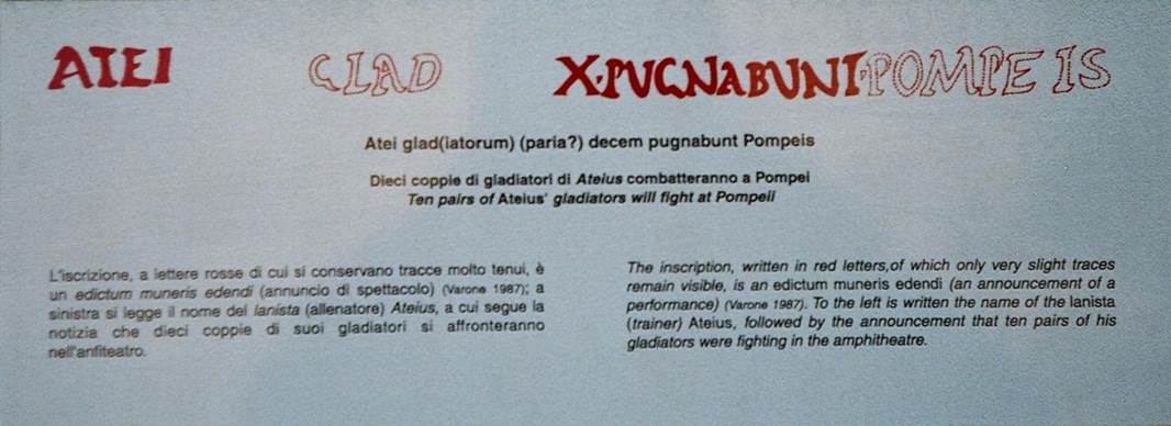 IX.8.2 Pompeii. October 2009. Explanation of painted latin inscription. Atei glad(iatorum) (paria?) decem pugnabunt Pompeis. Ten pairs of Ateius’ gladiators will fight at Pompeii. Photo courtesy of Rick Bauer.