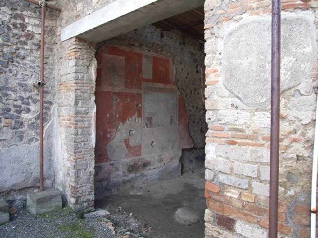 IX.9.c Pompeii. March 2009. Doorway to triclinium. The lower part of the walls (zoccolo) was black, and the walls were red.
In the centre of the south and west and walls was a large painting, whilst the painting and plaster from the north wall had fallen.
See Notizie degli Scavi di Antichità, 1889, p.128.



