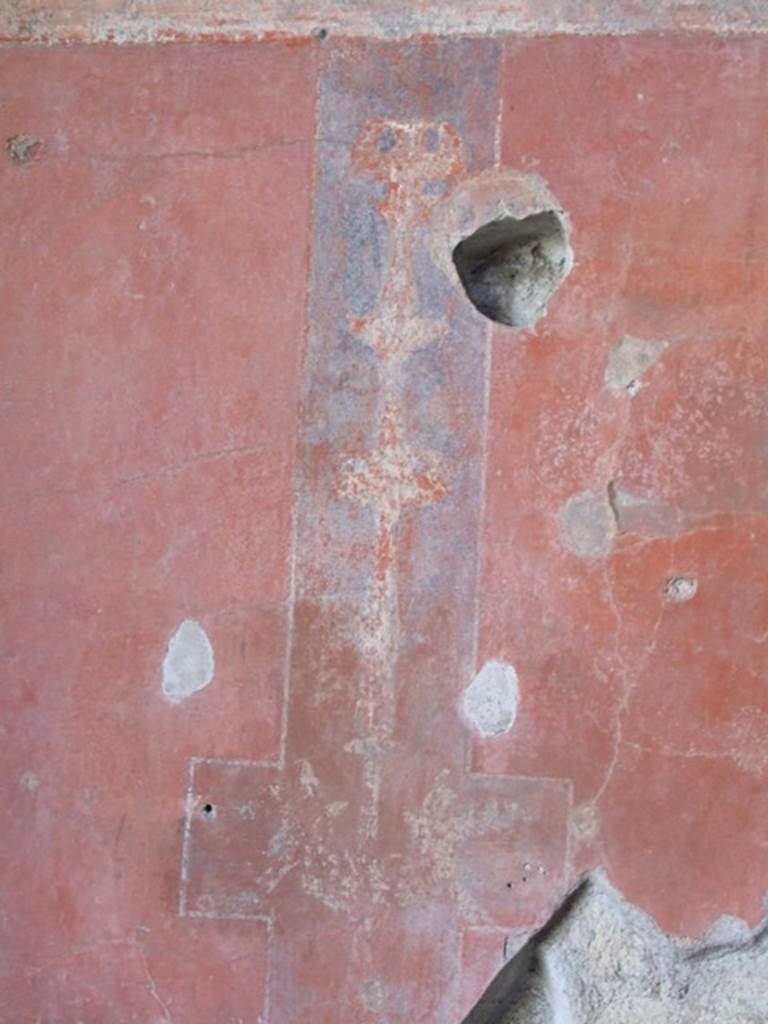 IX.9.c Pompeii. March 2009. Candelabrum in a narrow black compartment on a red wall, wall decoration from east end of south wall of triclinium.

