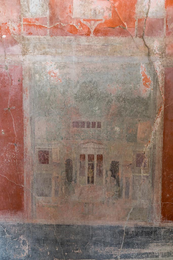 IX.9.c Pompeii. March 2023. 
Architectural painting from centre of west wall of triclinium, with figures and statue of a divinity. 
Photo courtesy of Johannes Eber.
