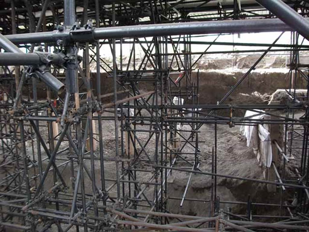 IX.11.7 (rear of) Pompeii. May 2010. Columns from peristyle being excavated at north end, on west side of IX.12.