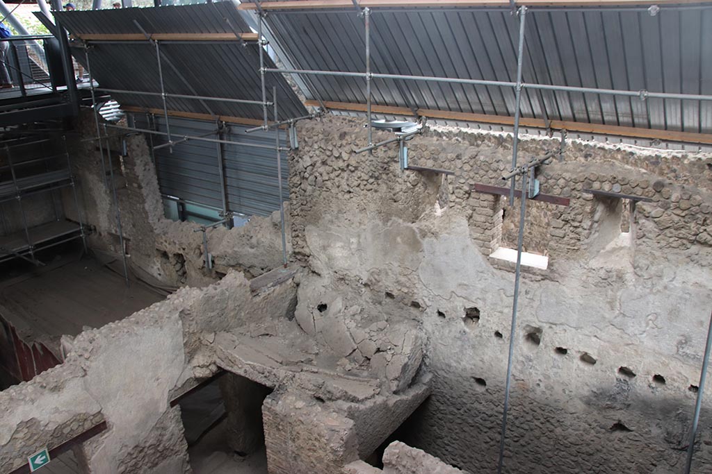 IX.12.6 Pompeii. October 2024. 
Looking north-east from above room “n1”, towards Stable “n”, on left, upper east wall of insula, and room “o”. Photo courtesy of Klaus Heese.
