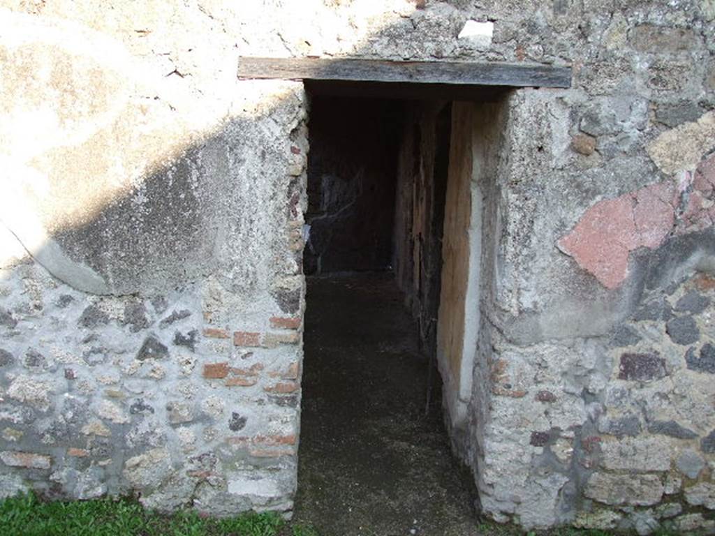 HGW24 Pompeii. December 2006. Doorway to baths complex in east wall of peristyle.