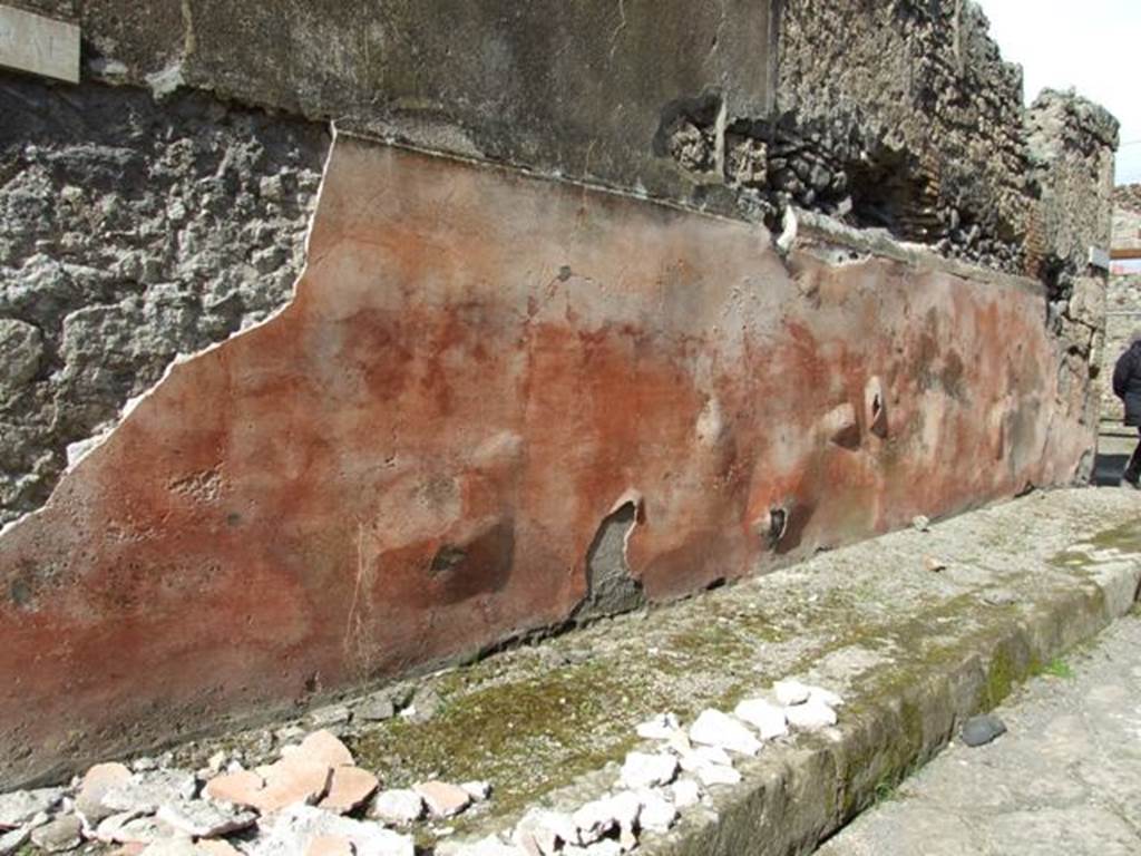 Vicolo di Balbo. North side. Looking east to junction. March 2009. Painted plaster on outside wall of IX.2.16, bulging and falling onto the pavement.