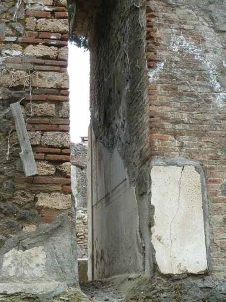 Pompeii Porta Nocera. May 2010.
Space between 12EN and 10EN, with remains of plaster on 10EN. Looking south. 
