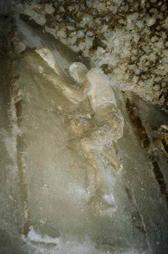 Pompeii, outside Porta Nocera. July 2010. Plaster cast of a third fleeing victim, found in 1956/7. Photo courtesy of Rick Bauer. 