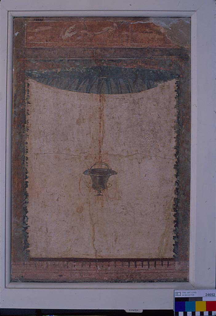 Villa della Pisanella, Boscoreale. Fresco fragment. Decorative compartment with border and top piece. 
Compartment is a room enclosed by a four sided frame or border. 
Suspended vase in middle. Rosette and leaves partially visible. Birds in top panel.
According to De Cou, this is 24655.
The suspended vase is like that of the other fresco (No. 24652), but the details are more clearly preserved. 
In the interior of the top-piece the base-line is visible, but of the figures only indistinct blotches remain. 
One of these (on the left side) may have been a horse, the others are small and shapeless.
From the close resemblance existing between this piece and No. 24652 it is very probable that they are corresponding pieces from the same wall.
See De Cou F. Antiquities from Boscoreale in Field Museum Of Natural History (January 1, 1912), p. 165, pl. CXXIII.
Photo © Field Museum of Natural History - CC BY-NC.
Now in the Field Museum, where it is shown as 24655 See in Field Museum and as part of inventory number 24652 See in Field Museum. 
